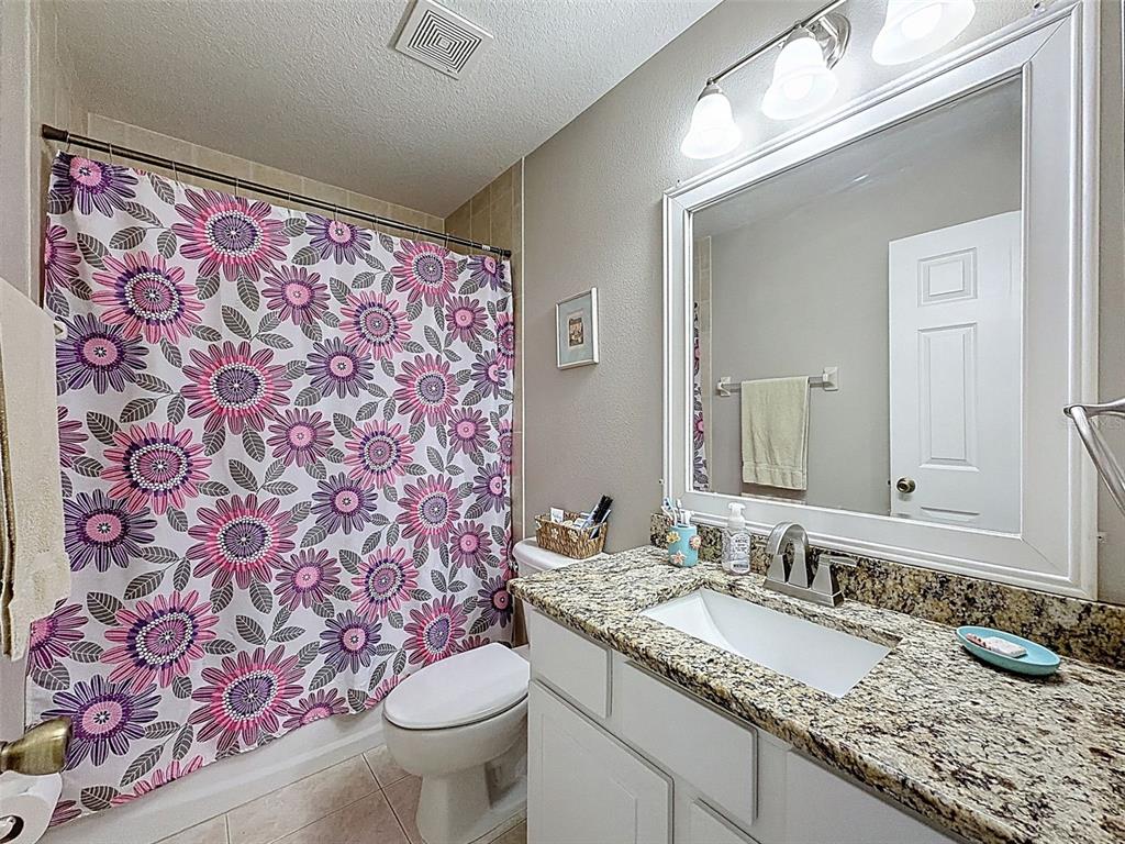 12105 Maripoe Road Weeki Wachee, FL 34614 - Photo 43 of 62 a bathroom with a granite countertop sink and a mirror
