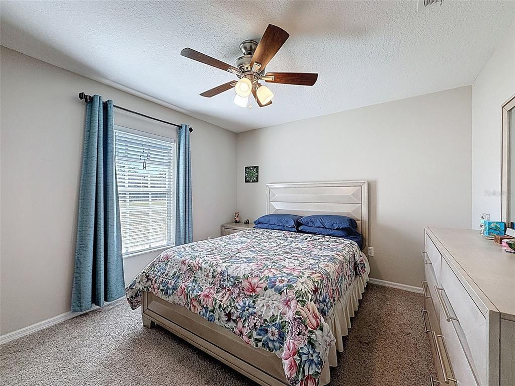 12105 Maripoe Road Weeki Wachee, FL 34614 - Photo 44 of 62 a bedroom with a bed and a window