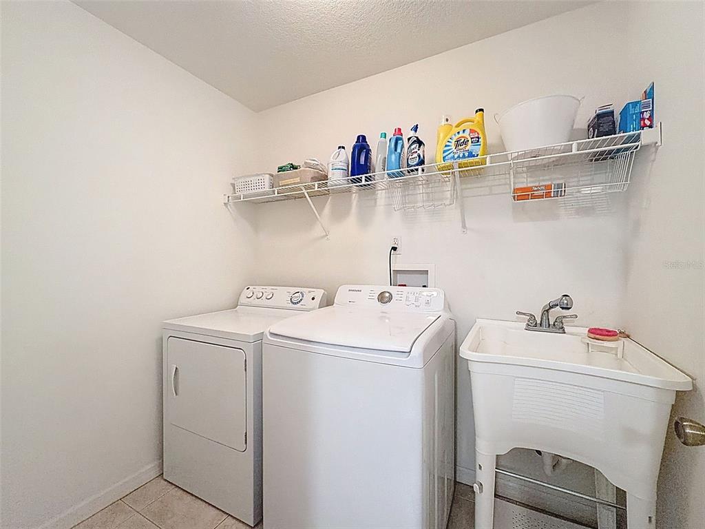 12105 Maripoe Road Weeki Wachee, FL 34614 - Photo 46 of 62 a utility room with dryer and washer