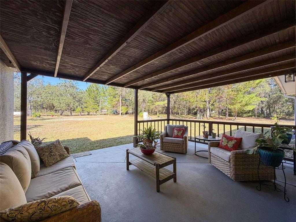 12105 Maripoe Road Weeki Wachee, FL 34614 - Photo 47 of 62 a living room with furniture and floor to ceiling windows