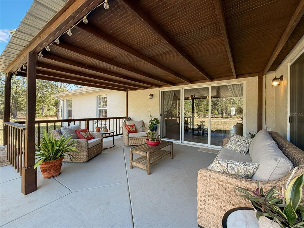 12105 Maripoe Road Weeki Wachee, FL 34614 - Photo 49 of 62 a living room with patio furniture and a potted plant