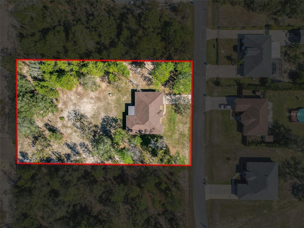 12105 Maripoe Road Weeki Wachee, FL 34614 - Photo 61 of 62 an aerial view of a house with a yard and garden