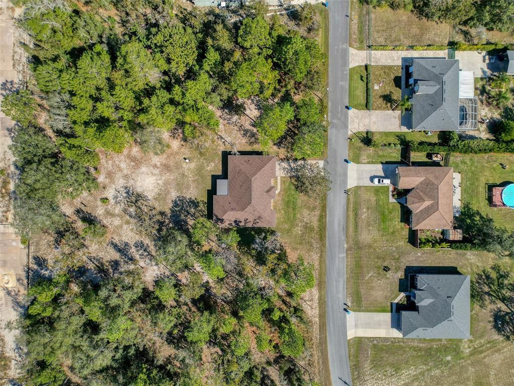 12105 Maripoe Road Weeki Wachee, FL 34614 - Photo 62 of 62 an aerial view of a house with a yard and lake view