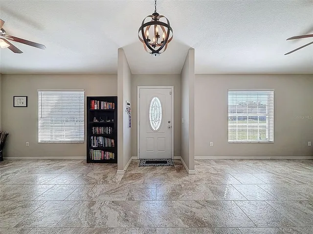 a large kitchen with stainless steel appliances granite countertop a refrigerator a oven and a sink