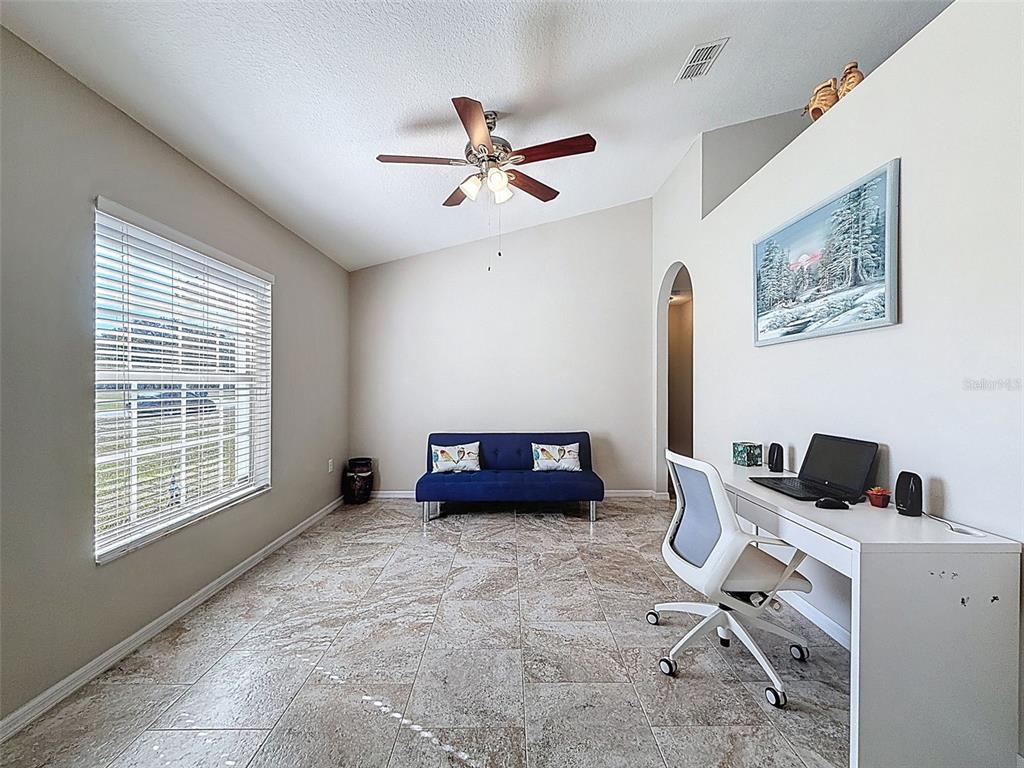 12105 Maripoe Road Weeki Wachee, FL 34614 - Photo 10 of 62 a bedroom with furniture and a window