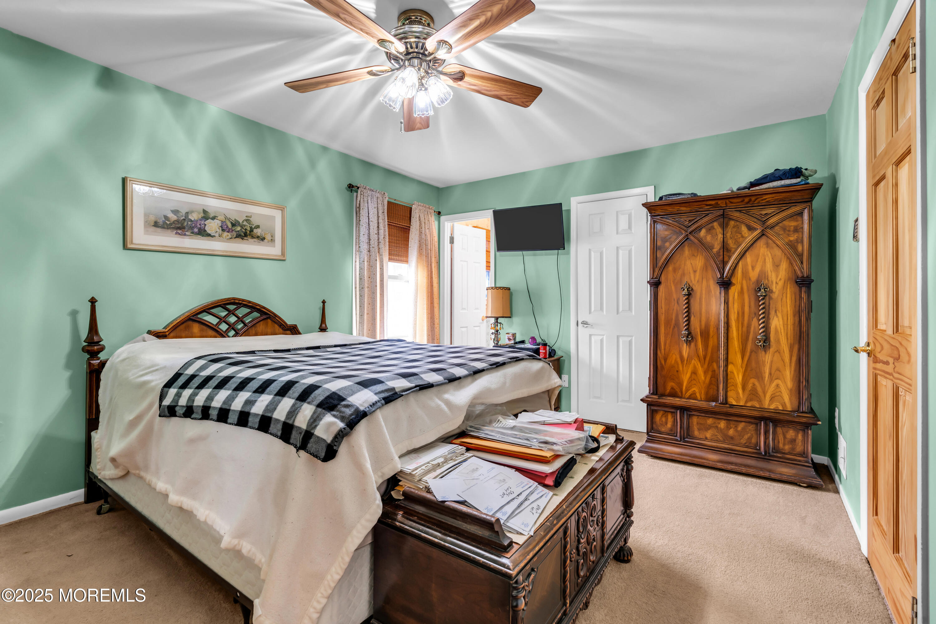 4 Evergreen Place Howell, NJ 07731 - Photo 17 of 27 a bedroom with a bed and a chandelier