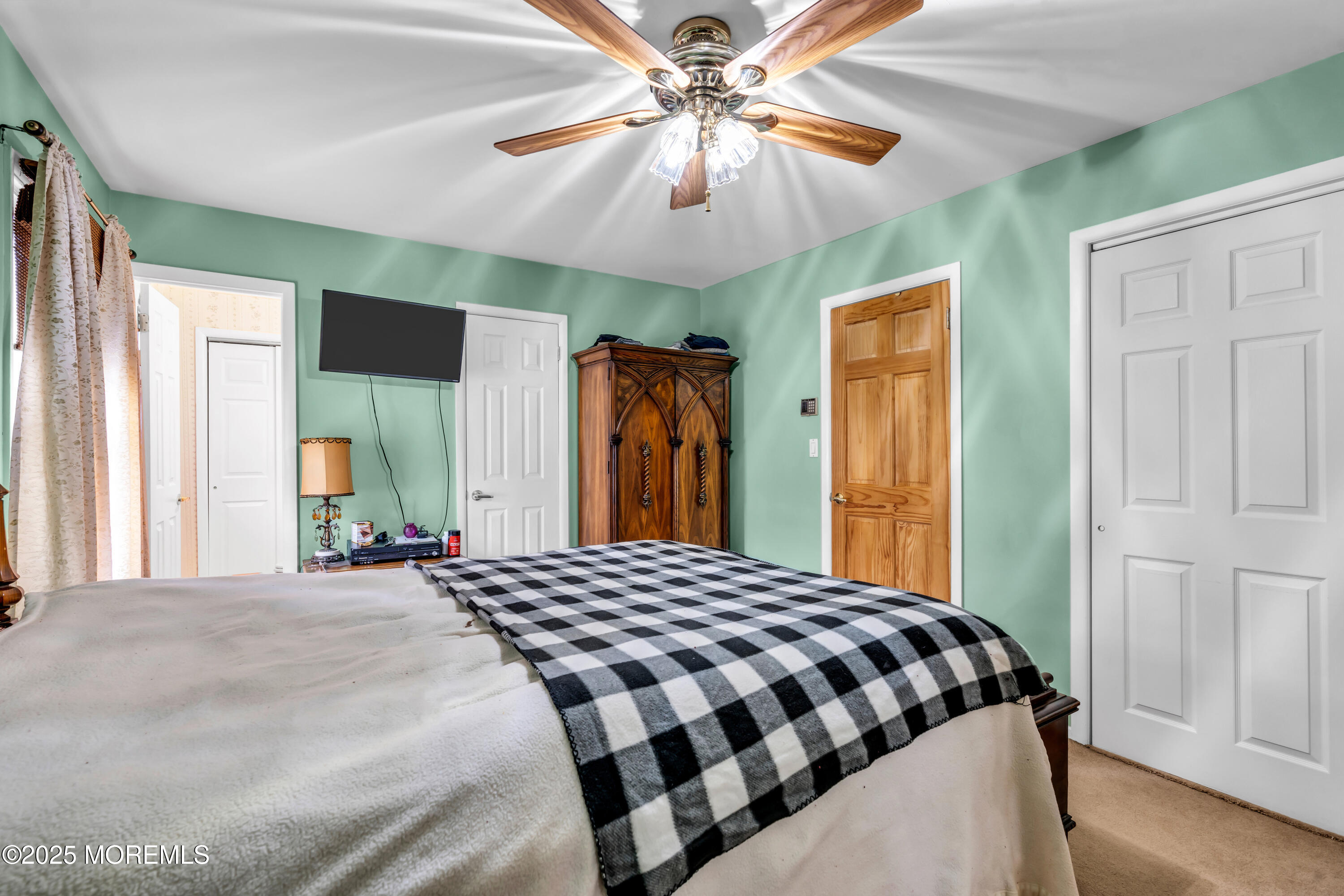 4 Evergreen Place Howell, NJ 07731 - Photo 18 of 27 a bedroom with a bed and a chandelier