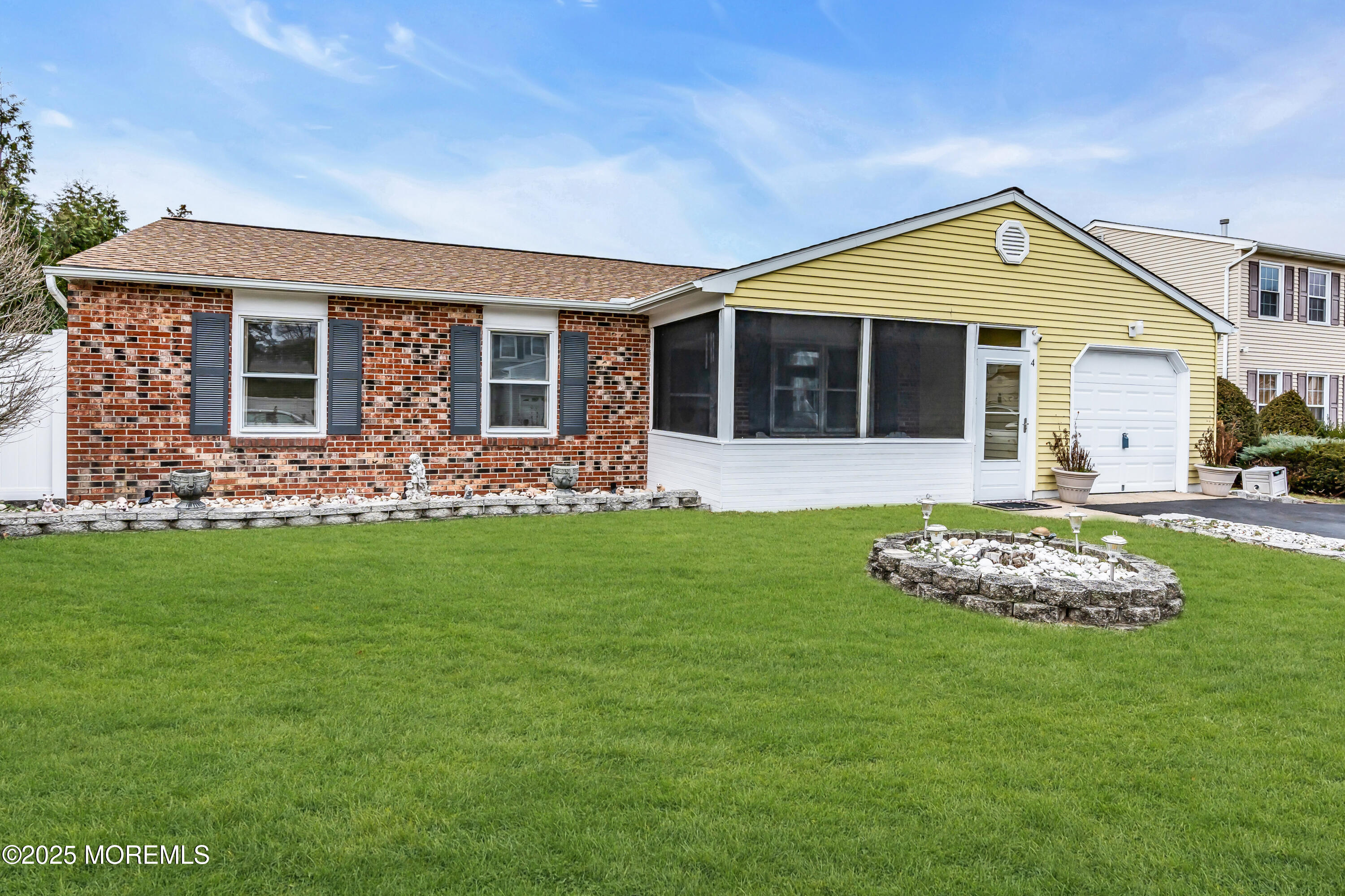 4 Evergreen Place Howell, NJ 07731 - Photo 2 of 27 a front view of a house with a garden