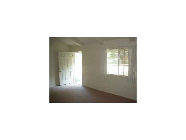 6900 Circle S Road Austin, TX 78745 - Photo 1 of 1 a open living room with a window and a fireplace