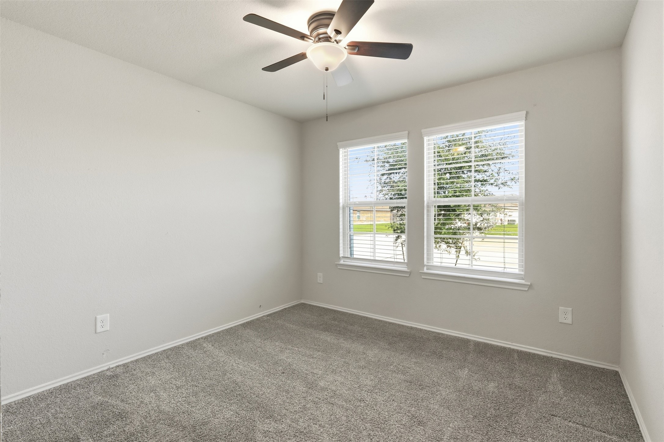2346 Gold Forsythia Ln Spring Spring, TX 77373 - Photo 26 of 39 Bright and inviting secondary bedroom with plush carpeting and ample natural light from large windows.