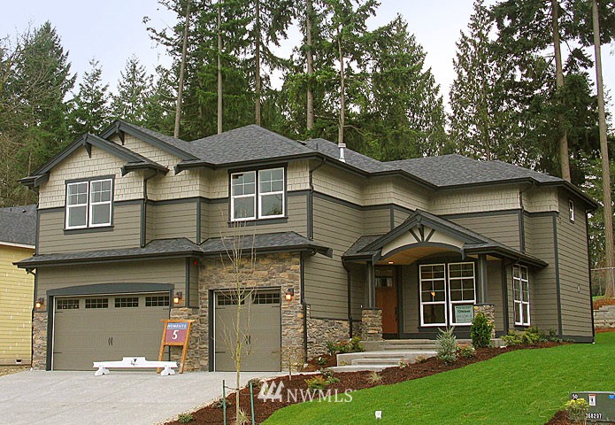202 233rd Place Southeast, Unit 25 Bothell, WA 98021 - Photo 1 of 1 a front view of a house with a garden