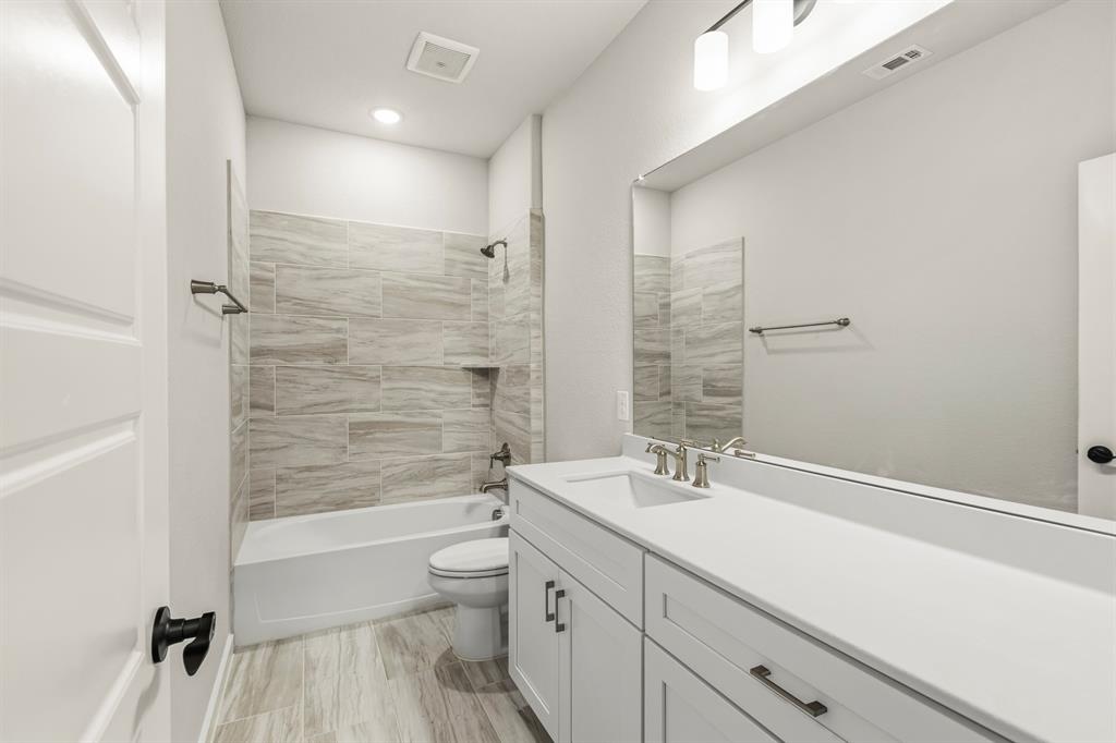 3311 Willena Road Melissa, TX 75454 - Photo 36 of 40 Bathroom featuring a vanity with integrated sink, white cabinetry, and a full-width mirror
