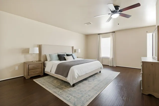 a bedroom with a bed and wooden floor