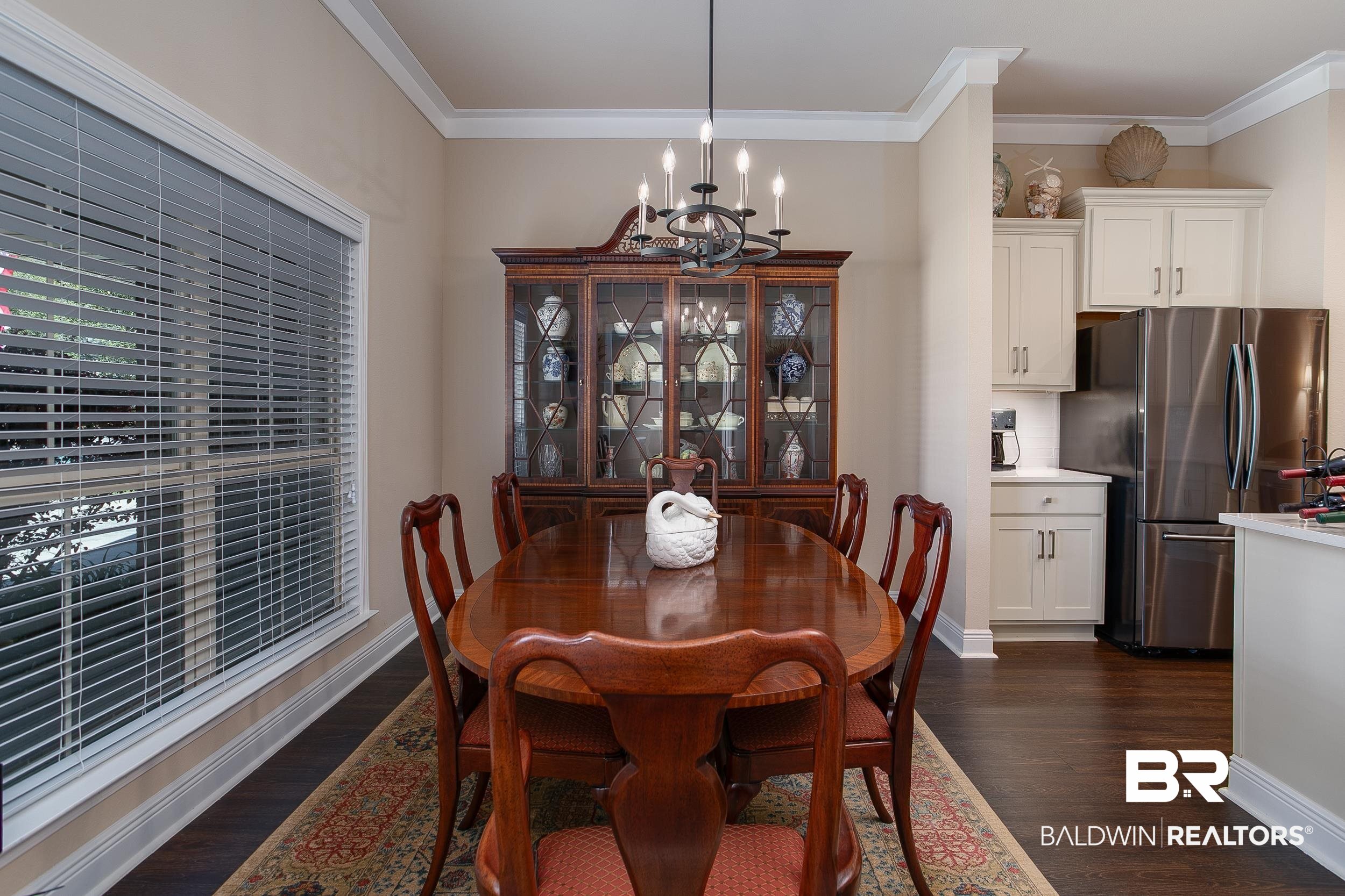 13154 Vincent Court Foley, AL 36535 - Photo 8 of 41 Dining space with an inviting chandelier, dark wood-style flooring, crown molding, and baseboards
