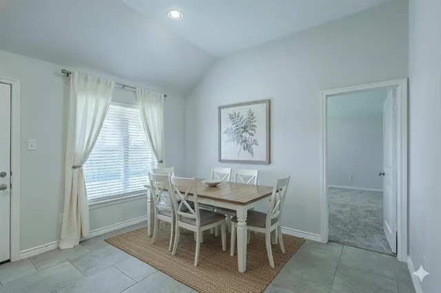 a dining room with furniture and window
