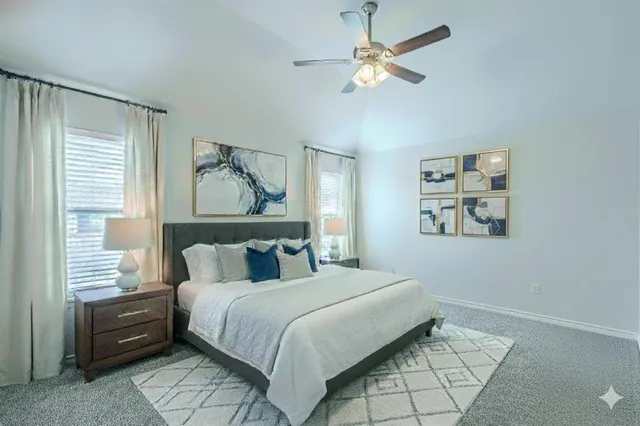 a bedroom with a large bed and a chandelier