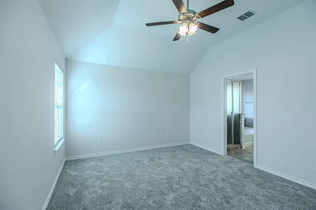 an empty room with closet and a chandelier fan