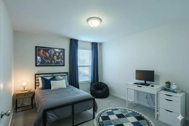 a bedroom with furniture and a flat screen tv