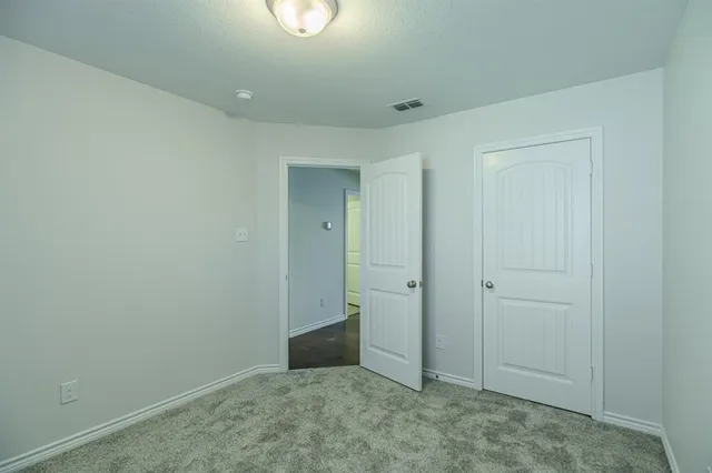 an empty room with closet area