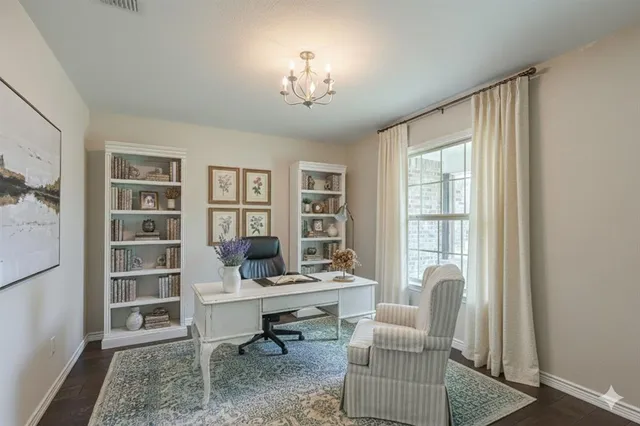 a view of a livingroom with workspace and a window