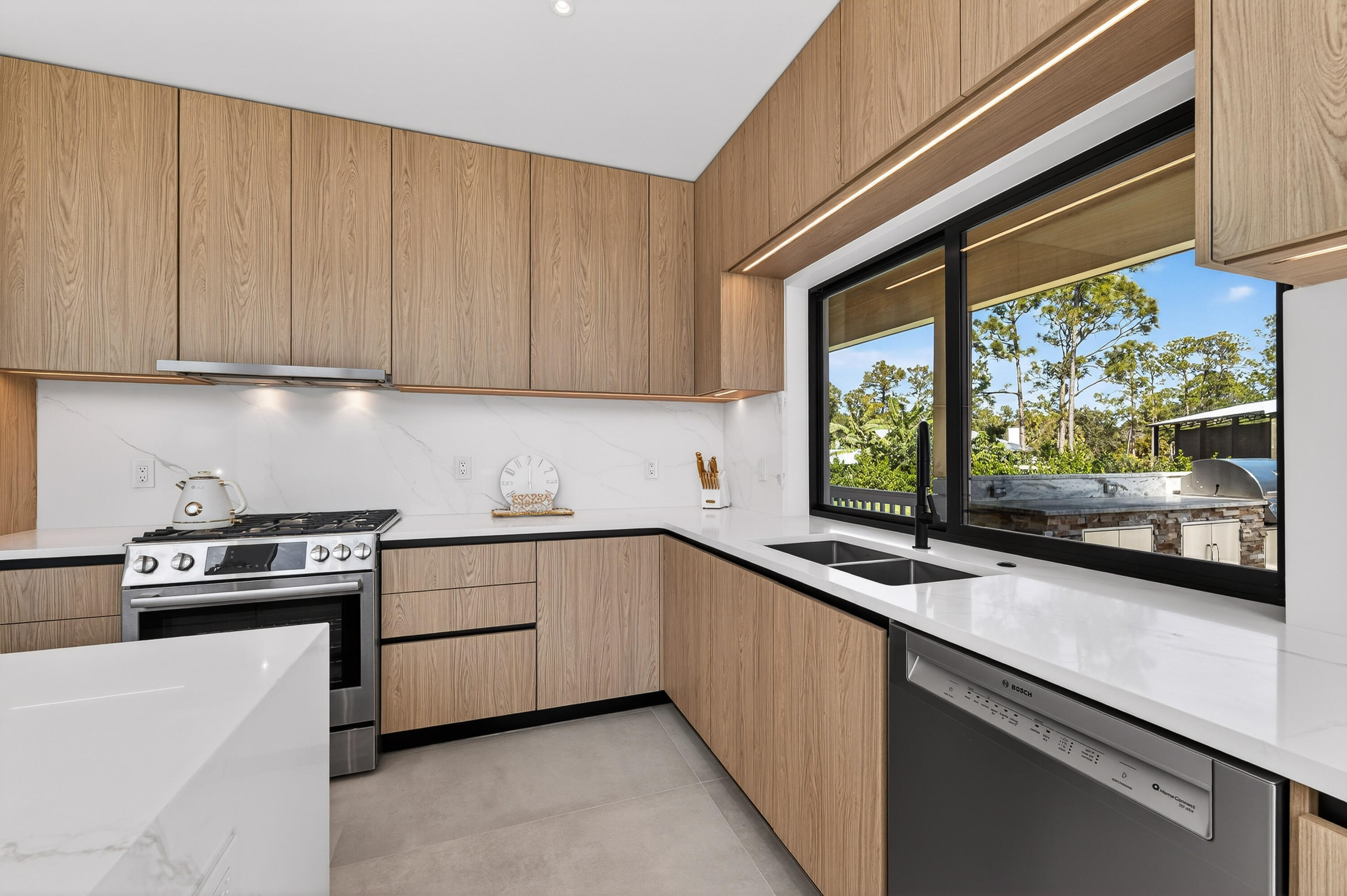 13613 157th Court North Jupiter, FL 33478 - Photo 11 of 54 a kitchen that has a sink and a stove