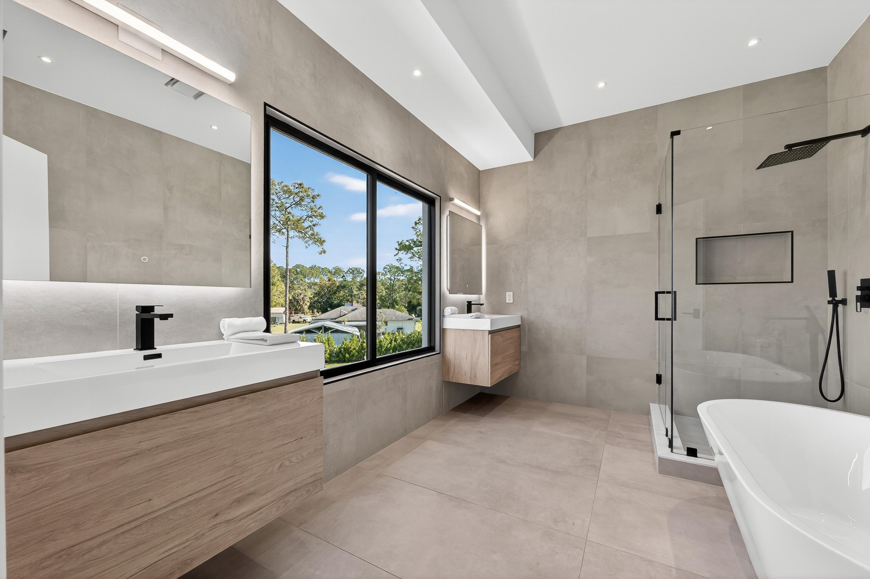 13613 157th Court North Jupiter, FL 33478 - Photo 16 of 54 a spacious bathroom with a tub mirror and window