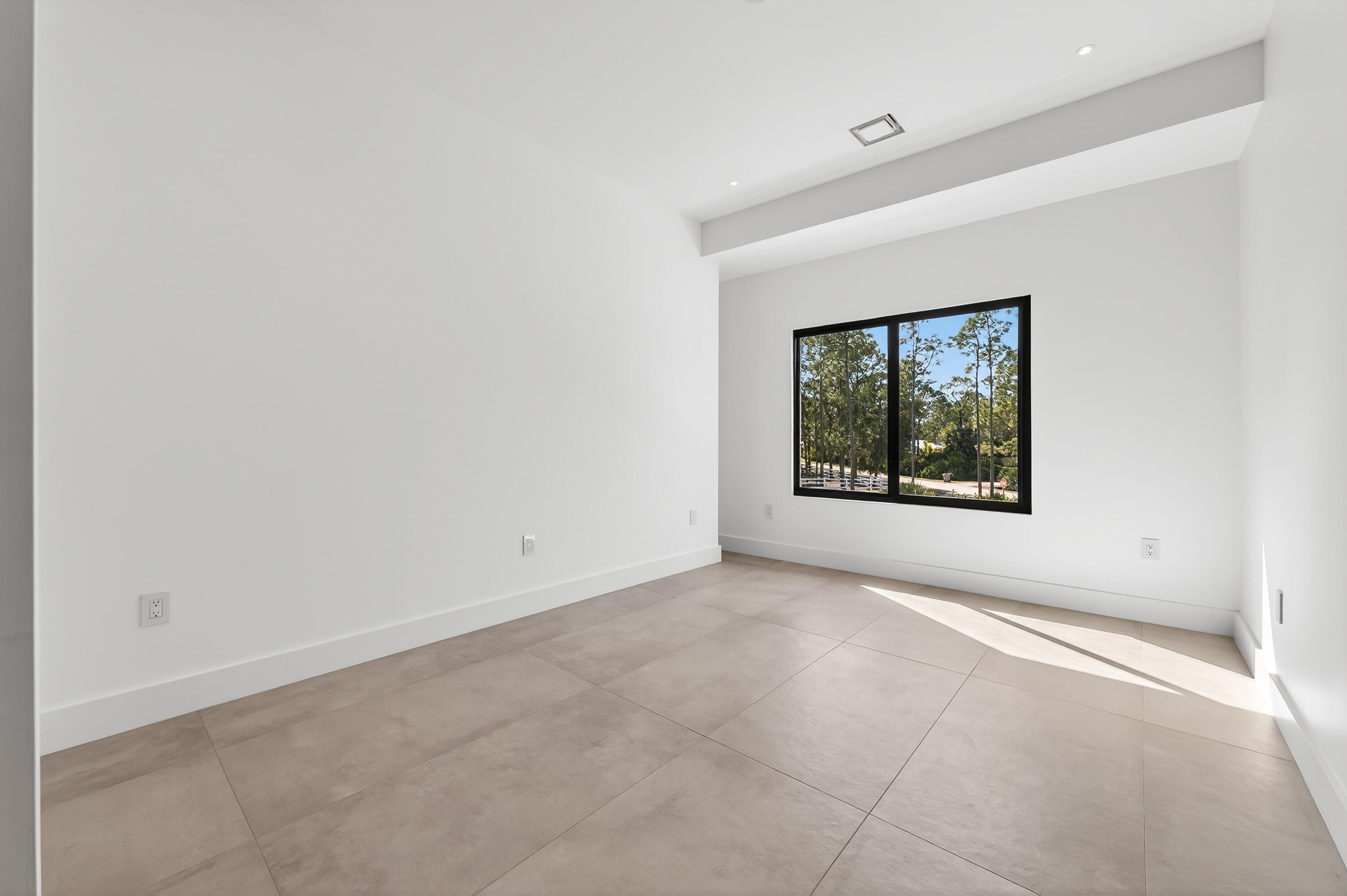 13613 157th Court North Jupiter, FL 33478 - Photo 20 of 54 an empty room with windows