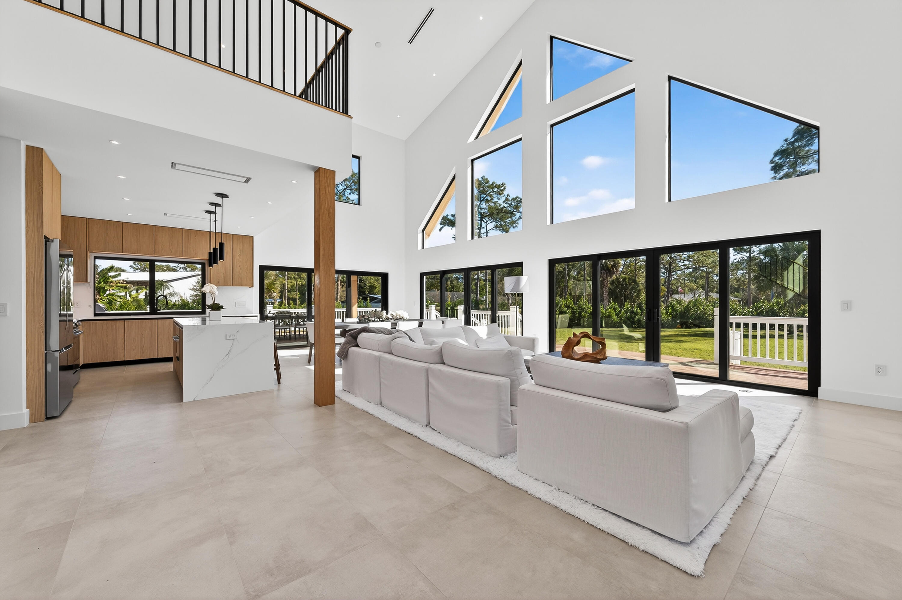 13613 157th Court North Jupiter, FL 33478 - Photo 2 of 54 a living room with furniture and large windows