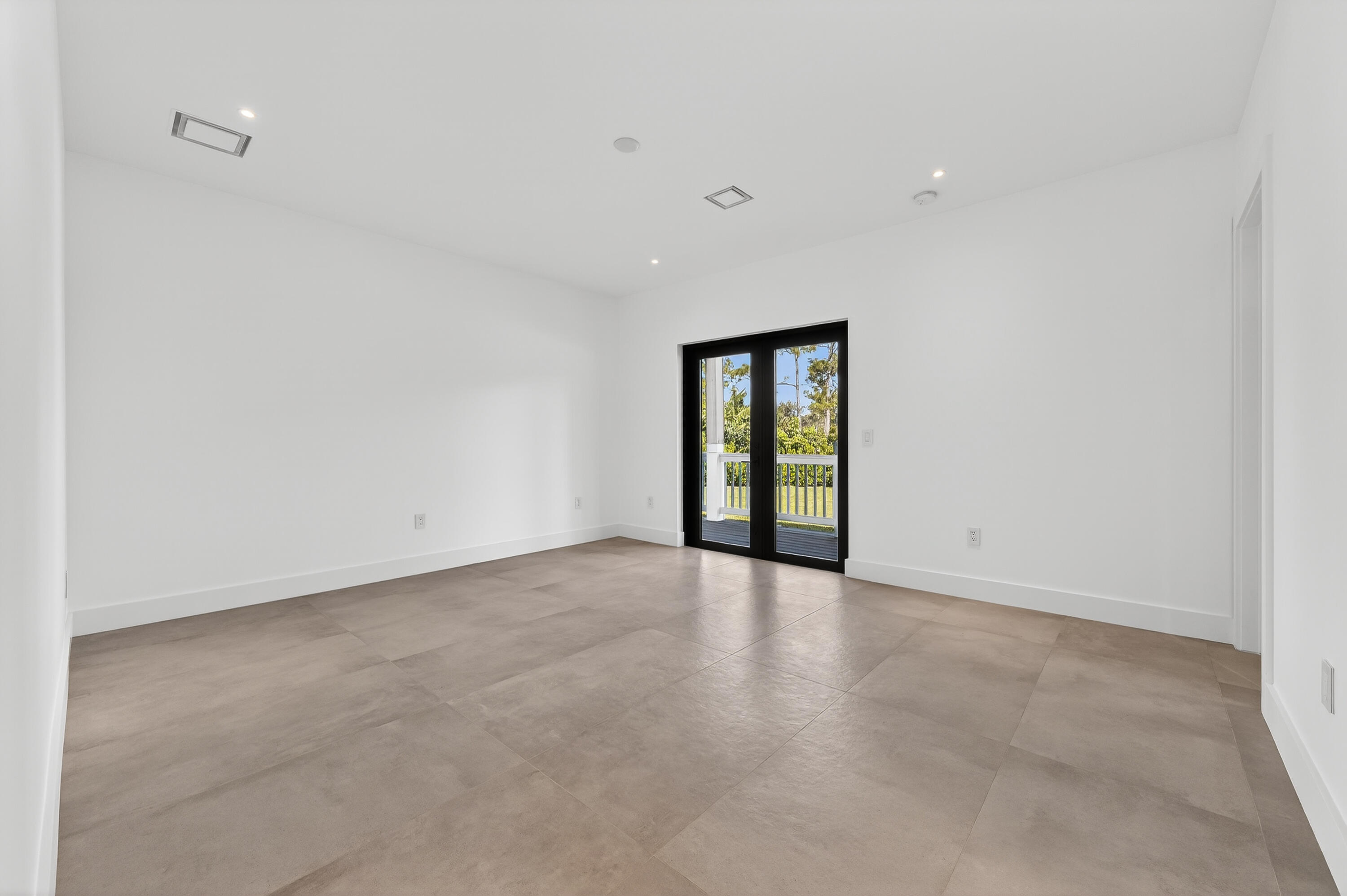 13613 157th Court North Jupiter, FL 33478 - Photo 27 of 54 a view of an empty room with a window
