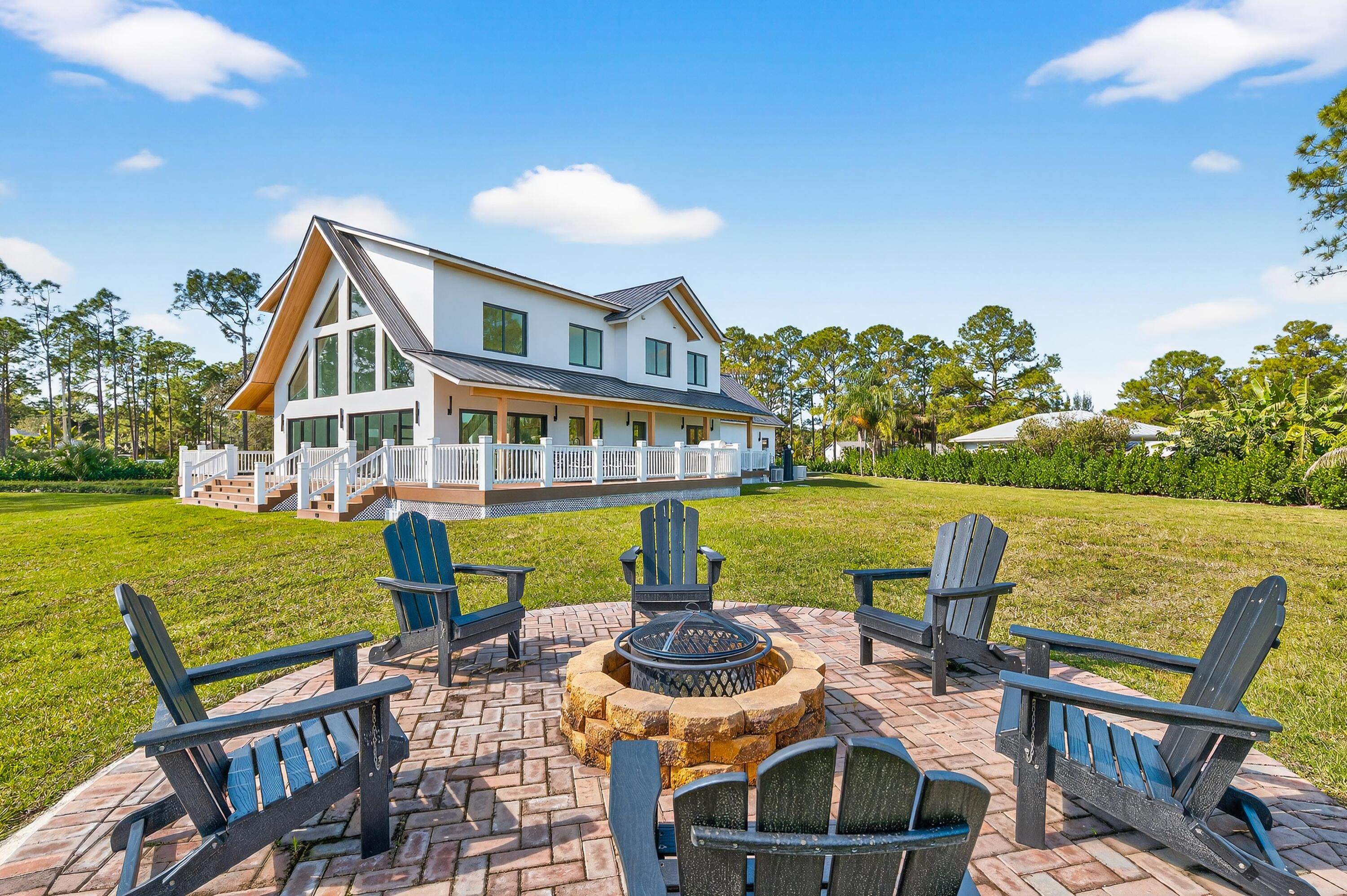 13613 157th Court North Jupiter, FL 33478 - Photo 4 of 54 a view of house with swimming pool outdoor seating and city view