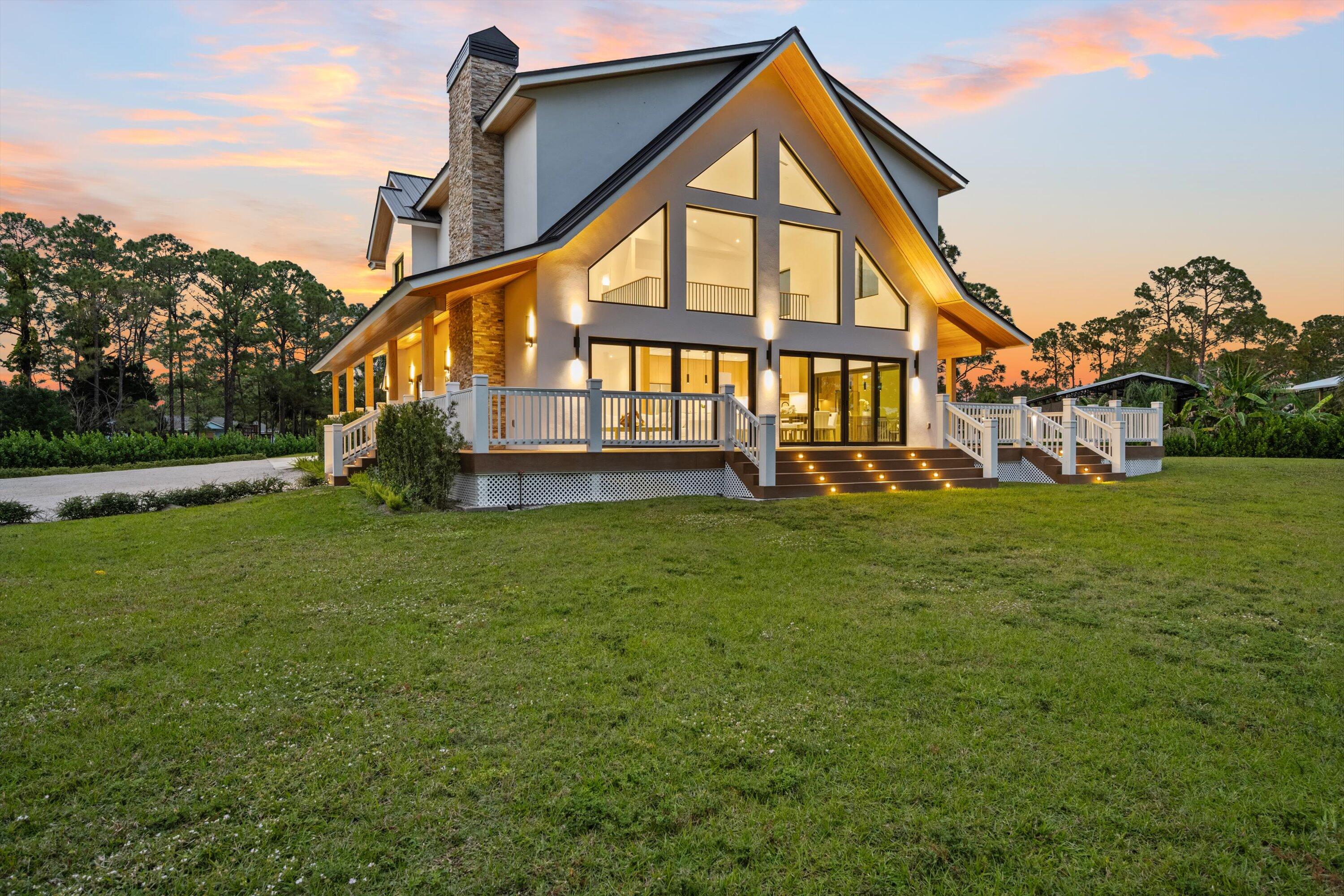 13613 157th Court North Jupiter, FL 33478 - Photo 44 of 54 a front view of a house with a yard