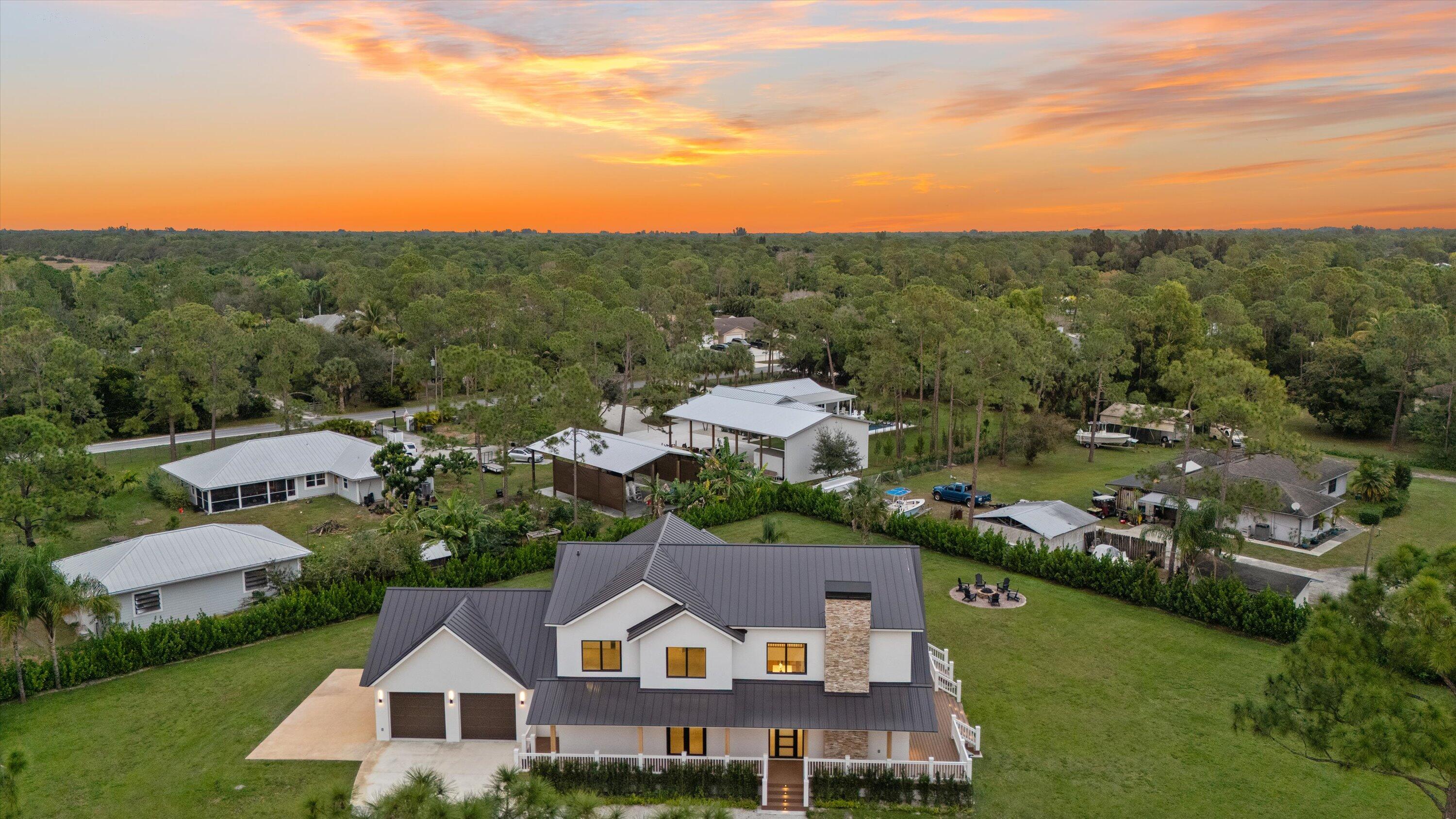 13613 157th Court North Jupiter, FL 33478 - Photo 49 of 54 an aerial view of residential houses with outdoor space and trees