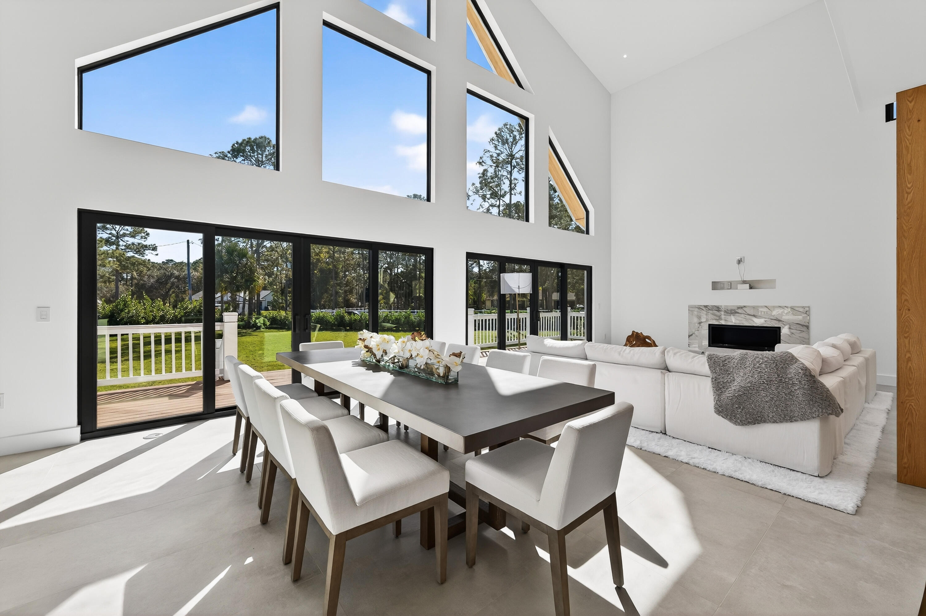 13613 157th Court North Jupiter, FL 33478 - Photo 6 of 54 a dining room with furniture and a floor to ceiling window