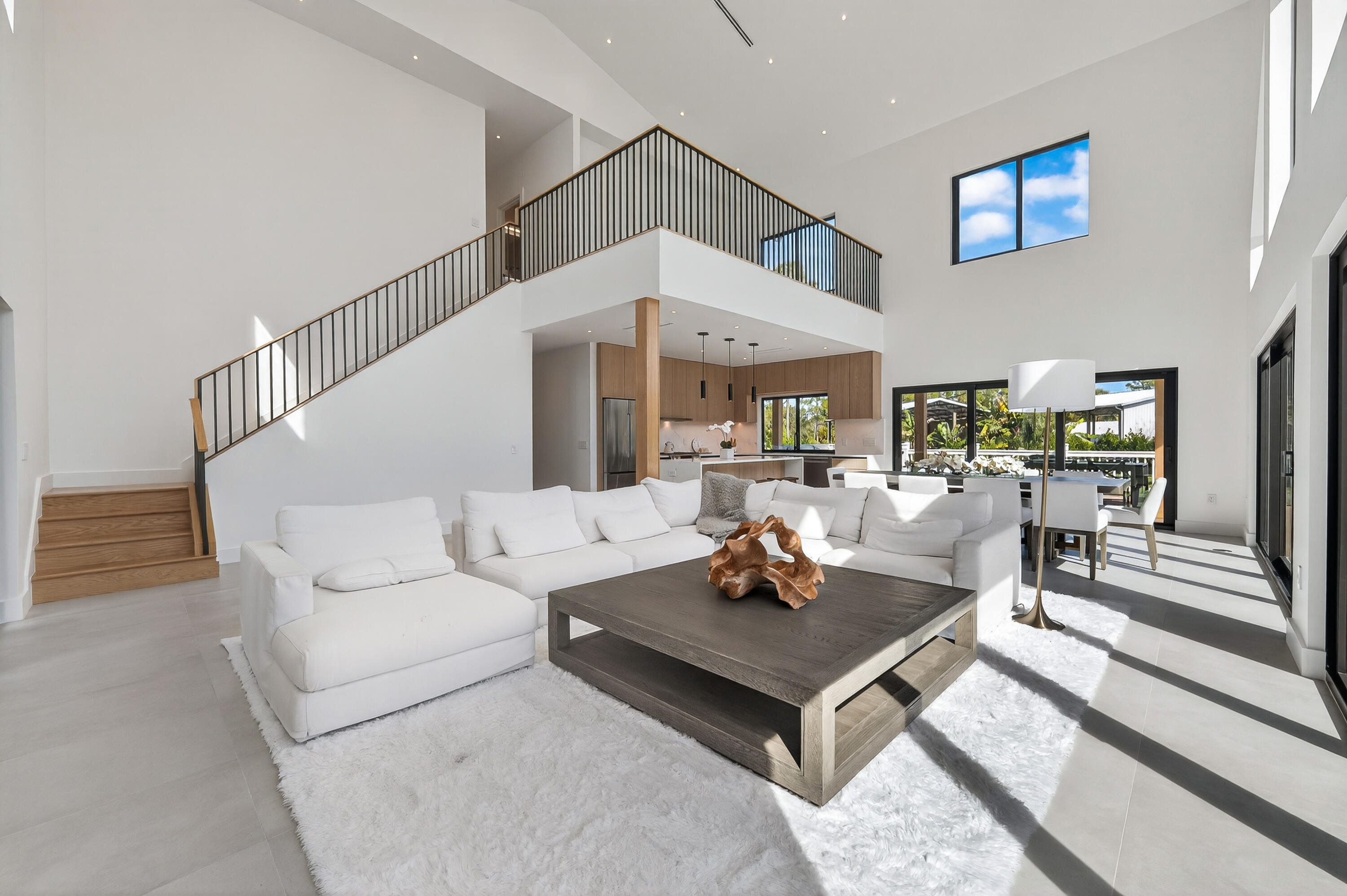 13613 157th Court North Jupiter, FL 33478 - Photo 7 of 54 a living room with furniture a rug and a table