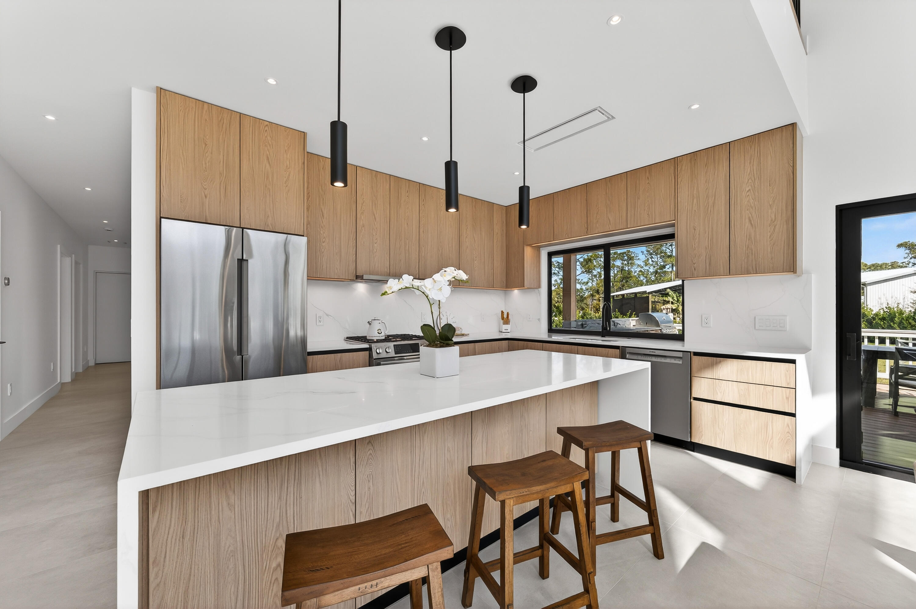 13613 157th Court North Jupiter, FL 33478 - Photo 10 of 54 a kitchen with stainless steel appliances a refrigerator a sink and a stove