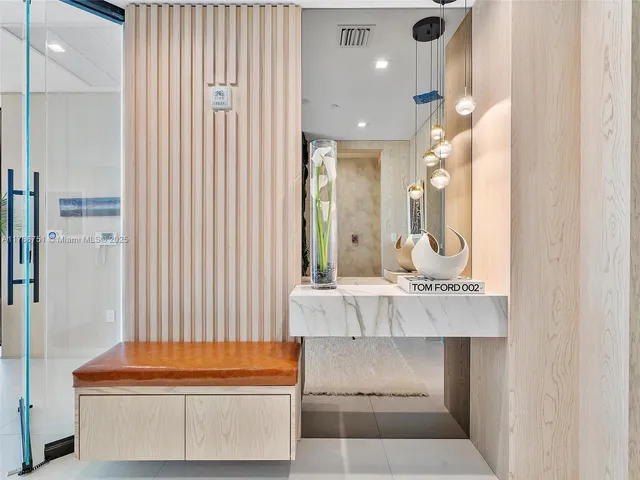 a bathroom with a tub sink and mirror