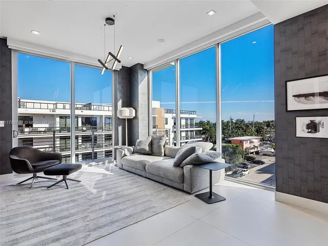 a living room with furniture a window and a kitchen view