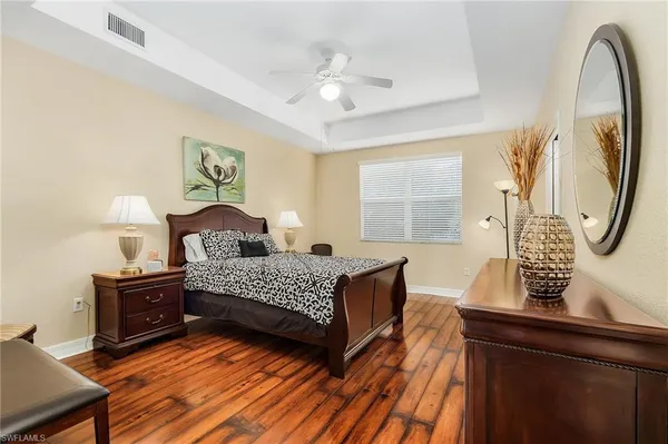 a bedroom with a bed and window with mirror