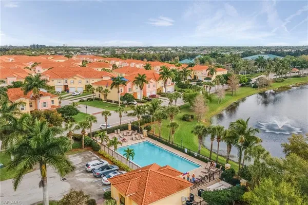 an aerial view of residential houses with outdoor space and lake view