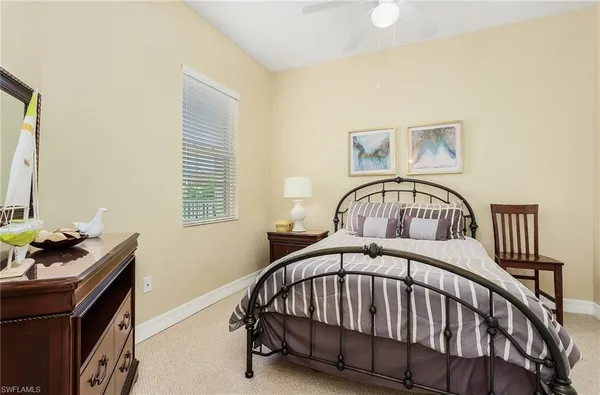 a bedroom with a bed next to a window