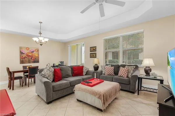 a living room with furniture and a chandelier