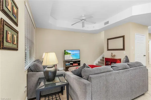 a living room with furniture and a lamp