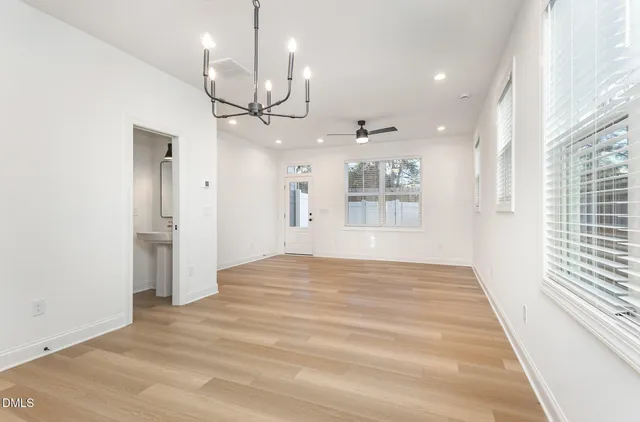 a kitchen with stainless steel appliances granite countertop a sink and dishwasher with white cabinets