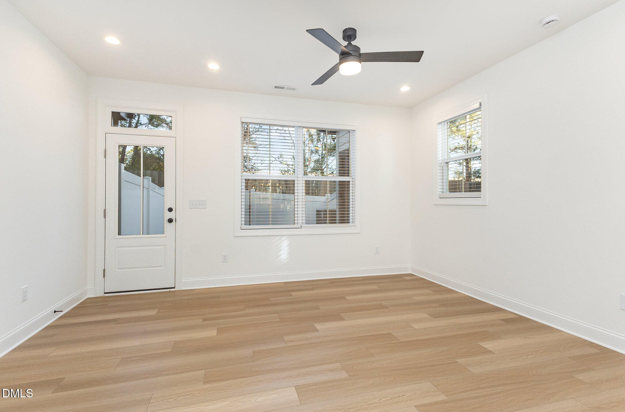 4801 Gossamer Lane, Unit 106 Raleigh, NC 27616 - Photo 13 of 42 a view of empty room with wooden floor and fan