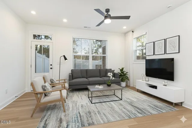 a living room with furniture and kitchen view