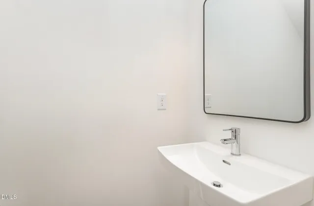 a view of a kitchen with a sink and a refrigerator
