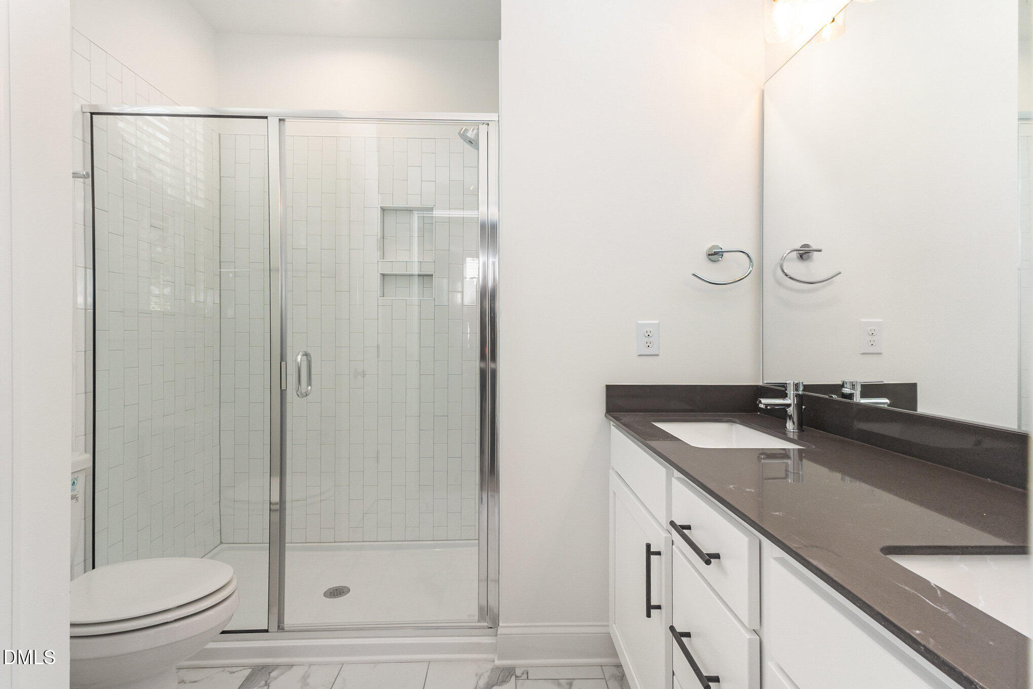 4801 Gossamer Lane, Unit 106 Raleigh, NC 27616 - Photo 20 of 42 a bathroom with a granite countertop sink a toilet and shower