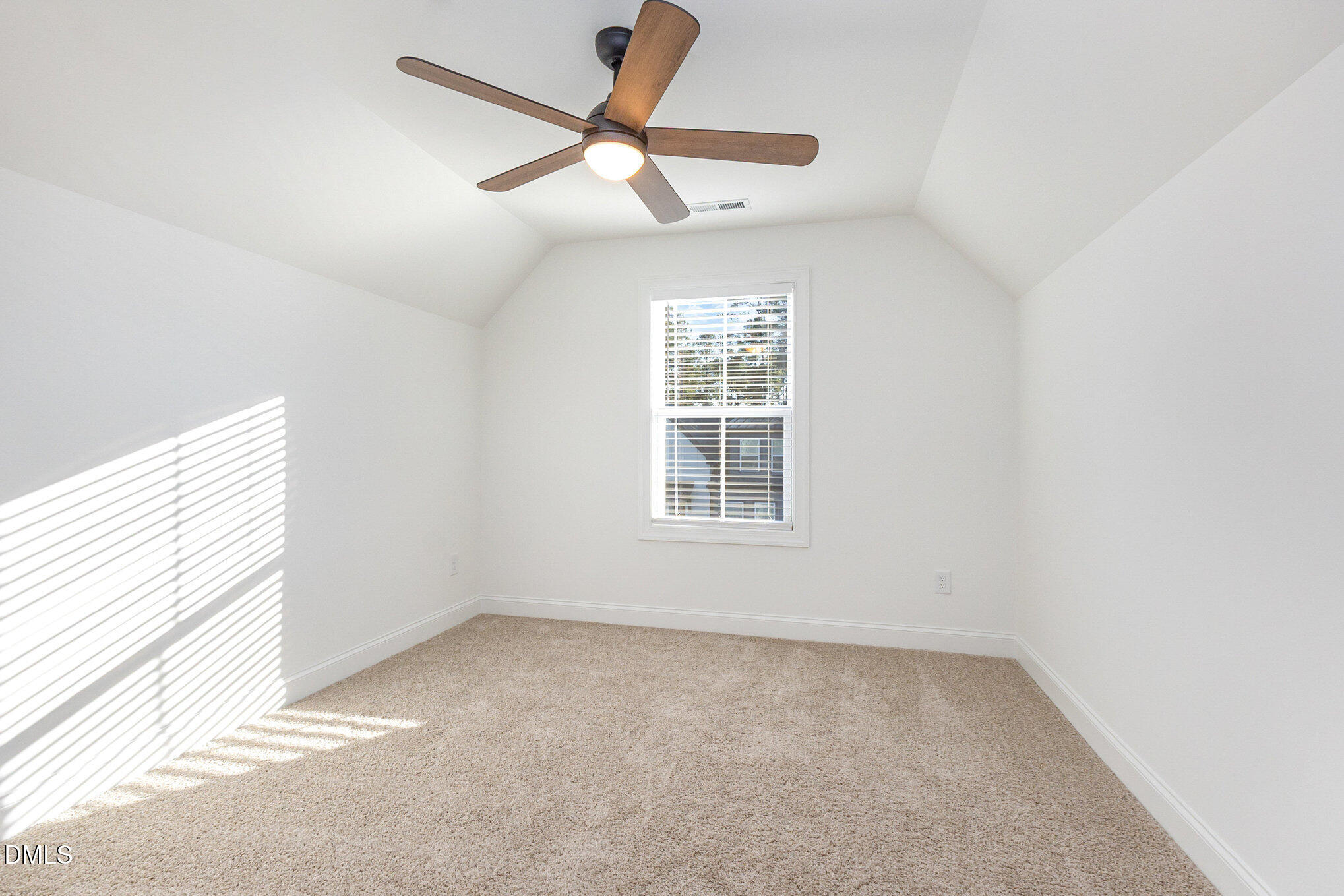 4801 Gossamer Lane, Unit 106 Raleigh, NC 27616 - Photo 27 of 42 an empty room with a window and a fan