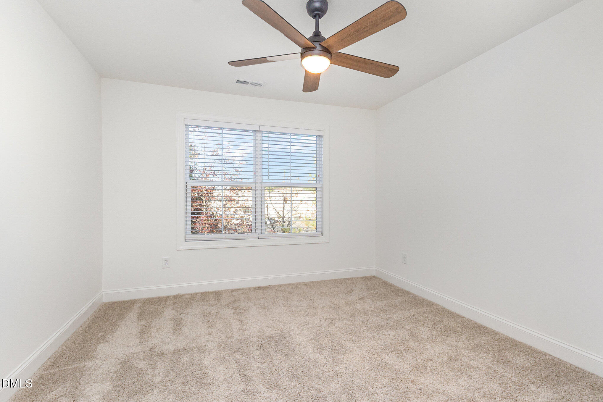 4801 Gossamer Lane, Unit 106 Raleigh, NC 27616 - Photo 31 of 42 an empty room with a window and a fan