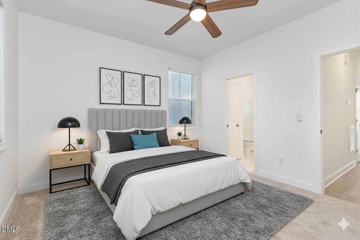 4801 Gossamer Lane, Unit 106 Raleigh, NC 27616 - Photo 33 of 42 a bedroom with a bed and a ceiling fan